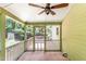 A screened in porch with a ceiling fan overlooks the expansive backyard with plenty of greenery at 212 Heidinger Dr, Cary, NC 27511