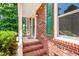 Close-up view of a brick porch with a white railing and decorative lighting at 212 Heidinger Dr, Cary, NC 27511