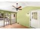 A screened in porch with wood floors and a ceiling fan, perfect for relaxing and enjoying the outdoors at 212 Heidinger Dr, Cary, NC 27511