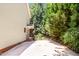 A wide side yard features a light green wall, a paved drive and a metal fence at 212 Heidinger Dr, Cary, NC 27511