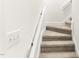 Carpeted staircase with white risers and handrail provides a safe and comfortable transition to upper floors at 212 Heidinger Dr, Cary, NC 27511