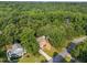 A stunning aerial view of a brick home surrounded by lush green trees at 2205 Bufflehead Rd, Raleigh, NC 27616