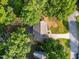Charming home aerial view with lush trees and a long driveway at 2205 Bufflehead Rd, Raleigh, NC 27616