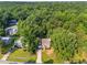 A beautiful brick home with a long driveway surrounded by green trees at 2205 Bufflehead Rd, Raleigh, NC 27616