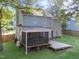 This backyard features a screened in porch, a wooden deck, and a well-manicured lawn, perfect for outdoor living at 2205 Bufflehead Rd, Raleigh, NC 27616
