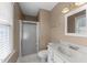 A bathroom with shower, single sink, and window offering natural light at 2205 Bufflehead Rd, Raleigh, NC 27616