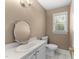 Half bath features a stylish mirror and ample natural light at 2205 Bufflehead Rd, Raleigh, NC 27616