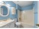 Cozy bathroom in blue features tub, shower, and vanity at 2205 Bufflehead Rd, Raleigh, NC 27616