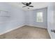 A carpeted bedroom with light blue walls, a ceiling fan, and window offering natural light at 2205 Bufflehead Rd, Raleigh, NC 27616