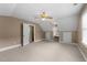 Large bedroom with carpet, a ceiling fan, and multiple windows at 2205 Bufflehead Rd, Raleigh, NC 27616