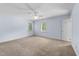 A carpeted bedroom with light blue walls, a ceiling fan, and two windows offering natural light at 2205 Bufflehead Rd, Raleigh, NC 27616