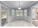 Dining area filled with natural light from large windows and sliding glass door at 2205 Bufflehead Rd, Raleigh, NC 27616