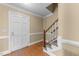 Entryway features hardwood floors, staircase, and paneled walls at 2205 Bufflehead Rd, Raleigh, NC 27616