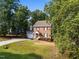 A well-kept brick home features an attached garage and landscaped front yard at 2205 Bufflehead Rd, Raleigh, NC 27616