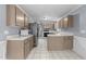 Well-lit kitchen boasts ample cabinet space and stainless steel refrigerator at 2205 Bufflehead Rd, Raleigh, NC 27616