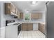 Kitchen features white appliances, white countertops and neutral cabinets at 2205 Bufflehead Rd, Raleigh, NC 27616