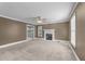 Spacious living room with neutral carpet, fireplace, and lots of natural light at 2205 Bufflehead Rd, Raleigh, NC 27616