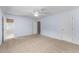 A spacious carpeted main bedroom with a ceiling fan, a private bath, and neutral walls at 2205 Bufflehead Rd, Raleigh, NC 27616