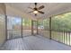 Relaxing screened porch features a ceiling fan and wooded backyard views at 2205 Bufflehead Rd, Raleigh, NC 27616