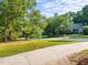 A quiet, tree-lined street with well-maintained lawns and houses set back from the road at 2205 Bufflehead Rd, Raleigh, NC 27616