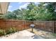 The backyard features a wooden fence, patio, and grill, creating the perfect space for outdoor enjoyment at 2213 Alpine Rd, Durham, NC 27707