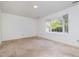 The room features carpeted floors and a large window offering natural light and an outside view at 2213 Alpine Rd, Durham, NC 27707