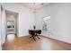 Open-concept dining area featuring hardwood floors, a chandelier, and natural light at 2213 Alpine Rd, Durham, NC 27707