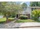Suburban home with front yard, sidewalk access, and mature shade tree at 2213 Alpine Rd, Durham, NC 27707