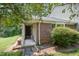 Charming brick home featuring a cozy, covered front entrance and landscaped yard at 2213 Alpine Rd, Durham, NC 27707