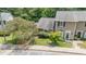 Well-maintained townhome with manicured lawn, mature trees, and welcoming entrance at 2213 Alpine Rd, Durham, NC 27707