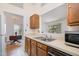 Well-lit kitchen with classic cabinets and an opening into the dining room at 2213 Alpine Rd, Durham, NC 27707