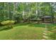 Mature backyard features a gazebo with seating, a shed, and is surrounded by mature trees at 224 Fleming Dr, Durham, NC 27712