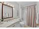 Bright bathroom with a shower and tub combo, neutral walls, and well-lit mirror at 224 Fleming Dr, Durham, NC 27712