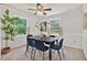 Bright dining room with a modern table, blue chairs, large windows, and neutral wall paint at 224 Fleming Dr, Durham, NC 27712