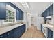 Bright kitchen features blue cabinetry, ample counter space, and a window over the sink at 224 Fleming Dr, Durham, NC 27712