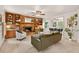 Spacious living room with brick fireplace, built-in shelving, ceiling fan, and an opening to the dining area at 224 Fleming Dr, Durham, NC 27712