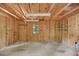 Unfinished shed with exposed beams features shelving, lighting, and a window at 224 Fleming Dr, Durham, NC 27712