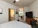 Spacious bedroom with views to the bathroom and living room, featuring a large TV and dresser at 2317 Gathering Square Ct, Fuquay Varina, NC 27526