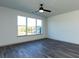 Spacious bedroom featuring a ceiling fan and bright, sunlit windows at 2321 Gathering Sq Ct, Fuquay Varina, NC 27526
