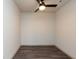 A simple bedroom with wood floors, a ceiling fan, and natural light at 2323 Gathering Sq Ct, Fuquay Varina, NC 27526