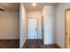 Inviting entryway featuring wood floors, a solid white front door and a coat closet at 2323 Gathering Sq Ct, Fuquay Varina, NC 27526