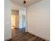 Hallway featuring neutral walls, wood flooring and views into a bathroom and bedroom at 2323 Gathering Sq Ct, Fuquay Varina, NC 27526