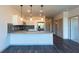 Modern kitchen with granite countertops, stainless steel appliances, and dark hardwood floors at 2323 Gathering Sq Ct, Fuquay Varina, NC 27526