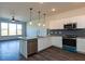 Well-lit kitchen boasts stainless appliances, granite counters, and island with eat-in bar at 2323 Gathering Sq Ct, Fuquay Varina, NC 27526