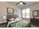 Bedroom with a tropical style bed set, side tables and a view of nature at 2323 Gathering Sq Ct, Fuquay Varina, NC 27526