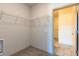 Practical walk-in closet with built-in shelving and doorway access at 2323 Gathering Sq Ct, Fuquay Varina, NC 27526