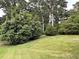 Expansive, well-manicured backyard featuring a variety of mature trees and shrubbery at 2331 Kennington Rd, Raleigh, NC 27610