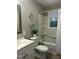 Bathroom with a white vanity, decorative mirrors, and shower-tub combo at 2331 Kennington Rd, Raleigh, NC 27610
