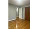 Neutral bedroom featuring hardwood floors, a closet, and an adjoining room at 2331 Kennington Rd, Raleigh, NC 27610