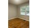 Cozy bedroom with hardwood floors and double windows offering outside views at 2331 Kennington Rd, Raleigh, NC 27610